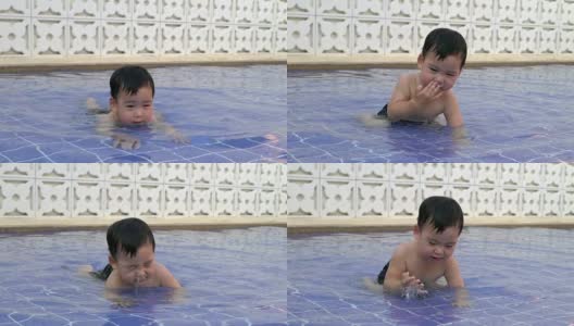 蹒跚学步的孩子在玩水时下沉的慢动作视频高清在线视频素材下载