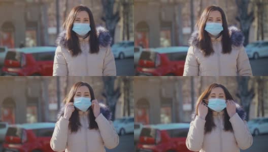 白天，一名留着黑色长发的女子站在城市街道上，戴着口罩，以抵御空气污染和冠状病毒高清在线视频素材下载