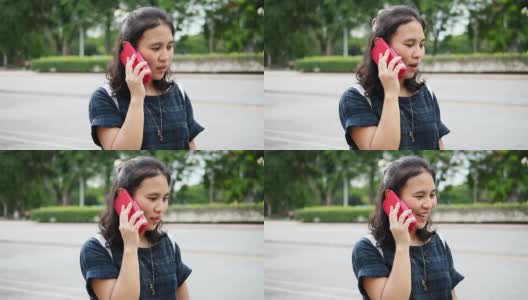 一个亚洲女人在打电话高清在线视频素材下载