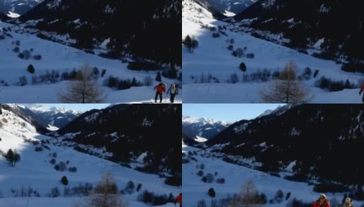 Mature couple back country ski above Swiss Alpine towns高清在线视频素材下载