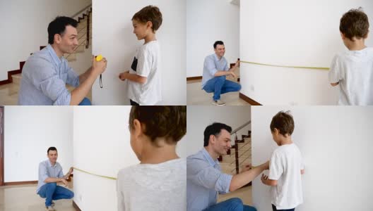 慈爱的父亲教他的儿子如何测量一堵墙指导他，看起来很自豪高清在线视频素材下载