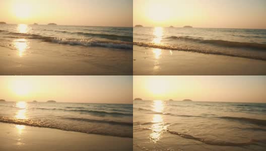 在夕阳的背景下，海滩上的海浪高清在线视频素材下载