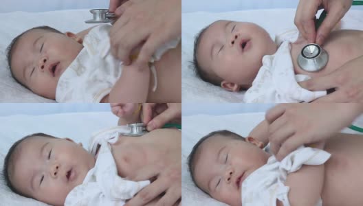 儿科医生检查婴儿。两个月大的亚洲女婴躺在医院病床上。高清在线视频素材下载