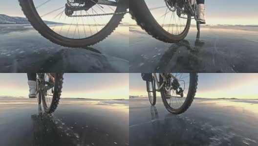 看轮胎。60 fps actioncam开枪。一个女人在冰上骑自行车。结冰的贝加尔湖的冰。自行车的轮胎上覆盖着特殊的尖钉。高清在线视频素材下载