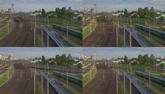 城市景观与许多铁路轨道在前景和移动的通勤客运列车高清在线视频素材下载
