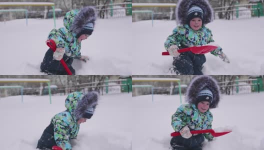 一个小孩在冬天的公园里玩雪。孩子拿着铁锹，在公园里积了很多雪。新鲜的空气里充满了乐趣和游戏。高清在线视频素材下载