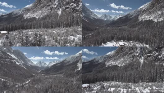 无人机飞行在高海拔山谷(双桥)与蓝天，雪林，山的背景高清在线视频素材下载