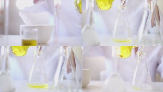 科学家在实验室里研制药物或化妆品。倒液体或油。制药科学技术概念。高清在线视频素材下载