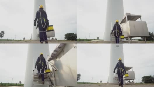 在泰国风电场，亚洲女工程师制服检查工程师准备和进度检查风力发电机的安全。高清在线视频素材下载