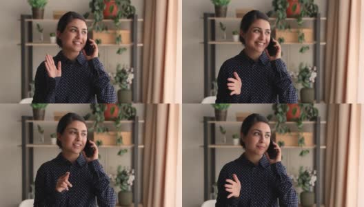 快乐年轻的印度民族商务女士拿着手机打电话谈话。高清在线视频素材下载