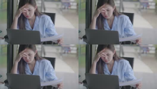 亚裔女性工作时坐着压力很大高清在线视频素材下载
