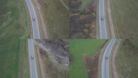 汽车正行驶在穿过田野的道路上，无人机拍下了鸟瞰图。秋天的时候在柏油路上，镜头跟着车走。高清在线视频素材下载