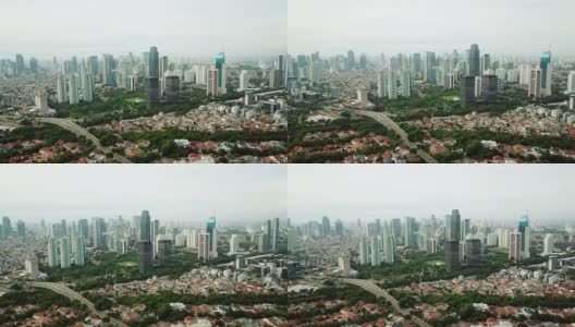 印尼雅加达，一架无人机从右向左飞行，拍摄了拥挤的住宅区附近摩天大楼的美丽航拍照片。拍摄分辨率为4k高清在线视频素材下载