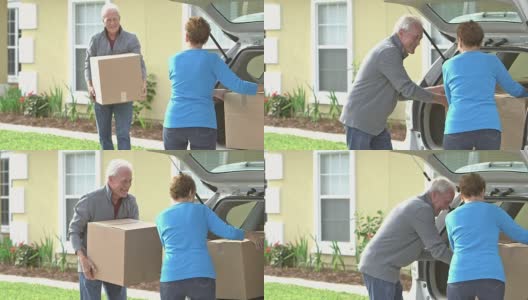 老夫妇把纸板箱从房子搬到车里高清在线视频素材下载