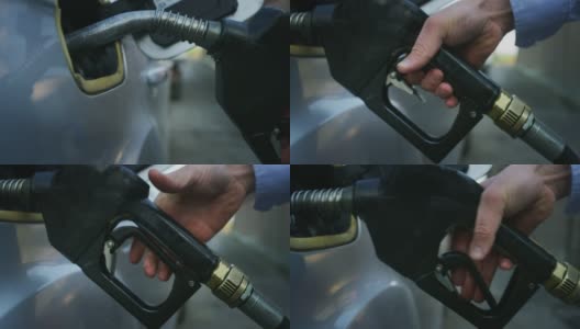在加油站，一名年轻男子的手正在给一辆汽车加油。概念:经济、能源、交通、汽油工业、绿色燃料、环境高清在线视频素材下载