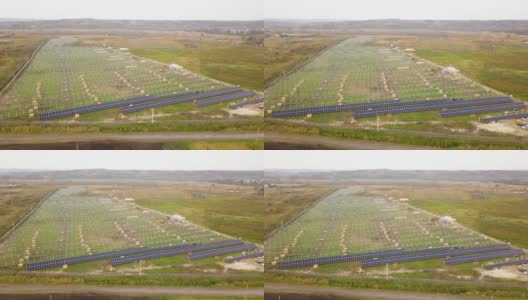 在绿地上建造太阳能发电厂的鸟瞰图。生产清洁生态能源的电板装配高清在线视频素材下载
