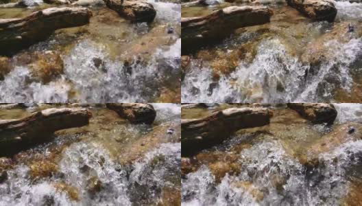 纯净的水在石头之间流动。山河汹涌的水流越来越近高清在线视频素材下载