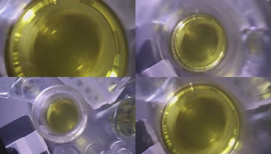 实验室特写玻璃烧瓶中透明黄色液体高清在线视频素材下载