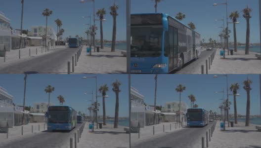 塞浦路斯。悲哀。05/20/2021两辆蓝色巴士沿着市中心的海边道路行驶。塞浦路斯岛上的公共交通。传统的公共汽车行驶在帕福斯的街道上高清在线视频素材下载