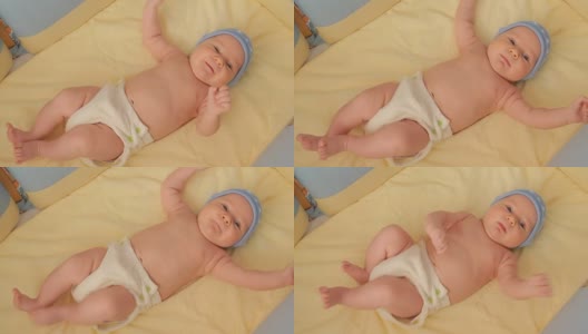 婴儿床里裹着尿布的小婴儿高清在线视频素材下载