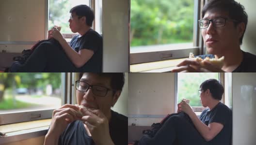 亚洲男子在火车上吃中国包子高清在线视频素材下载