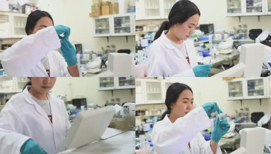 年轻的亚洲女科学家在实验室里用吸管工作高清在线视频素材下载