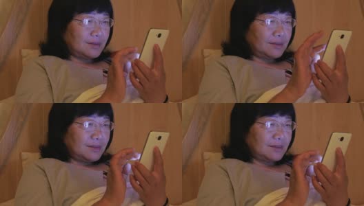 女人在卧室里用手机高清在线视频素材下载