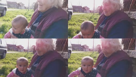 祖母手中幸福婴儿的肖像，近距离看。高清在线视频素材下载