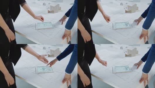 女性建筑师使用平板电脑，讨论平面图，握手高清在线视频素材下载