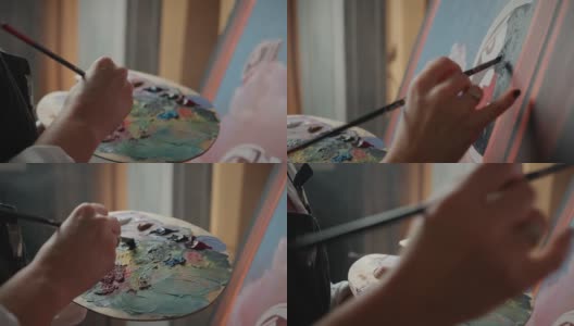 绘画的过程。无法辨认的女性艺术家从调色板和绘画图片，跟踪拍摄高清在线视频素材下载