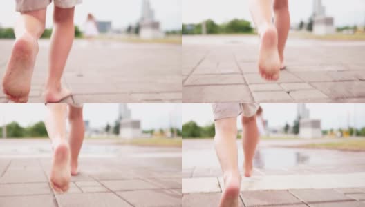 光着脚的小男孩跑进了城市街道的水坑里高清在线视频素材下载
