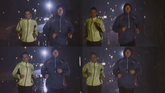 SLO MO TS夫妇晚上在城市街道上跑步高清在线视频素材下载