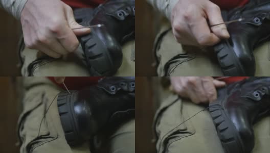 鞋匠的双手用锋利的锥子和黑色的线缝合高清在线视频素材下载