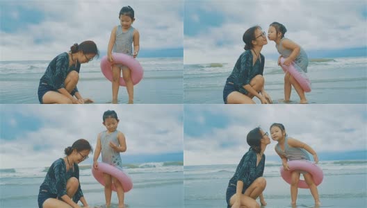 女孩在海滩上亲吻妈妈的脸颊高清在线视频素材下载