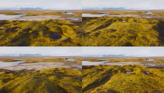 空中飞行在冰岛上空，从鸟瞰图上可以看到神奇的火山地貌，绿色的苔藓和蓝绿色的湖泊。美丽而原始的自然高清在线视频素材下载