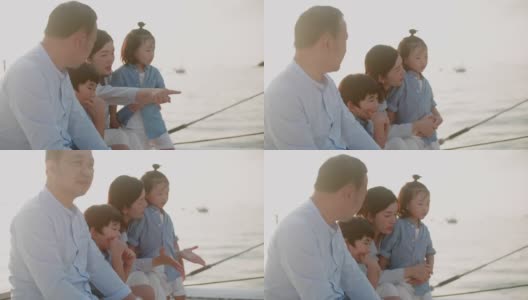 幸福的一家人在日落时分的游艇上玩得很开心高清在线视频素材下载