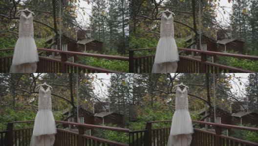 婚礼礼服挂在房子附近的树的背景下高清在线视频素材下载