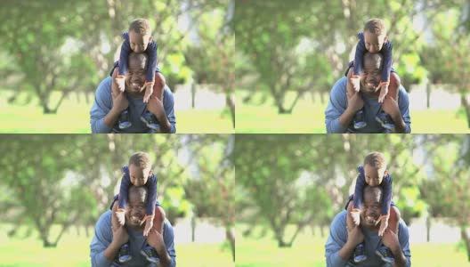 一个非裔美国小男孩在爸爸的肩膀上玩耍高清在线视频素材下载