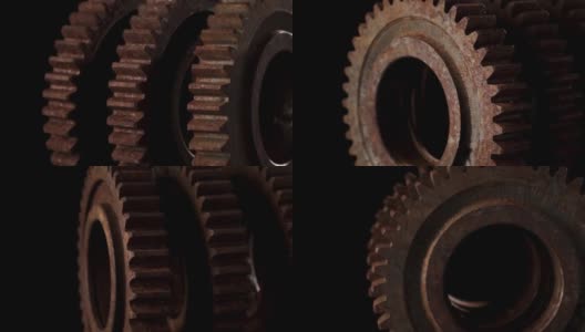 旋转的金属齿轮在一个黑色的背景特写高清在线视频素材下载