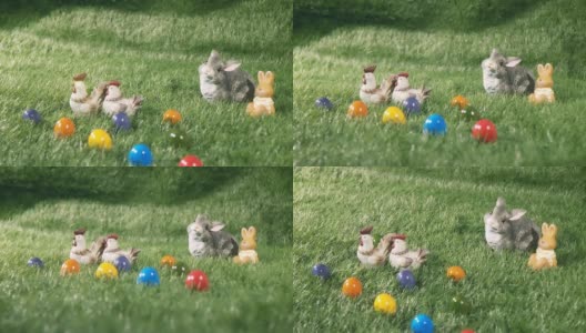 小兔子，小鸡和彩色的蛋躺在绿色的草地上高清在线视频素材下载
