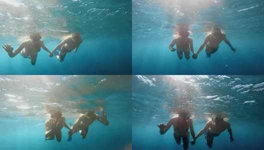 POV夫妇在阳光下牵手潜水高清在线视频素材下载
