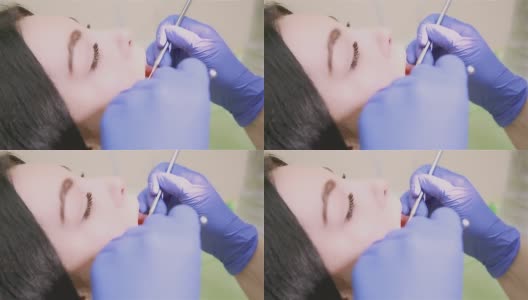 牙医使用医疗器械检查病人的口腔高清在线视频素材下载