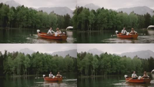 SLO MO新娘和她的新郎乘坐一艘船穿过一个湖高清在线视频素材下载