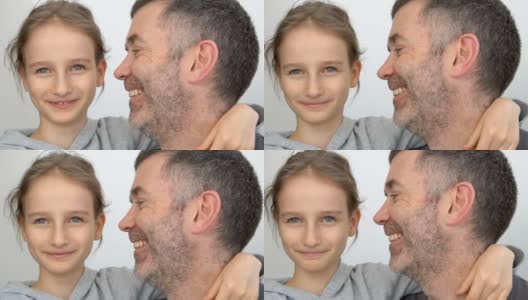 图为父亲和金发碧眼的小女儿们在室内拥抱微笑的全家福，庆祝父亲节的概念高清在线视频素材下载