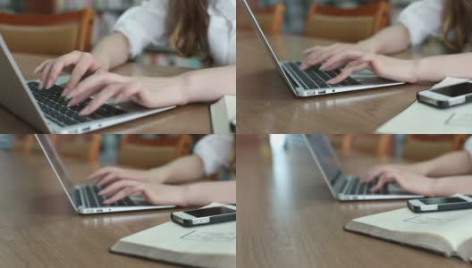 不认识的女学生在图书馆使用笔记本电脑，实时。高清在线视频素材下载
