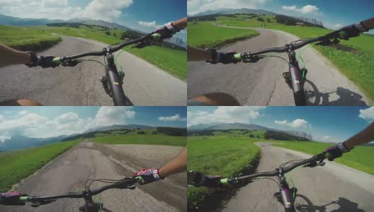 骑山地车骑自行车在弯弯曲曲的道路上高清在线视频素材下载