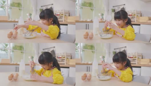 近距离亚洲快乐的年轻女孩在厨房做自制的面包店。可爱的小孩坐在桌子上，感觉快乐，享受在家学习烹饪食物或用手烘焙酵母面团高清在线视频素材下载