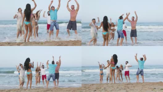 年轻人在海滩上蹦蹦跳跳高清在线视频素材下载