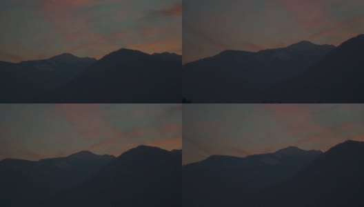 日落时分，在印度喜马偕尔邦的马纳里，积雪上方的橙色云朵覆盖着喜马拉雅山脉。山上的日落。自然背景。山上的天空变成了橘黄色。高清在线视频素材下载