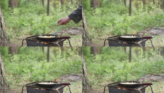 在营火上煮土豆。高清在线视频素材下载